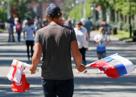 Soccer Football - FIFA World Cup - Group G - Tunisia v England - Volgograd, Russia - June 17, 2018 - A street vendor sells flags ahead of a match. REUTERS/Gleb Garanich