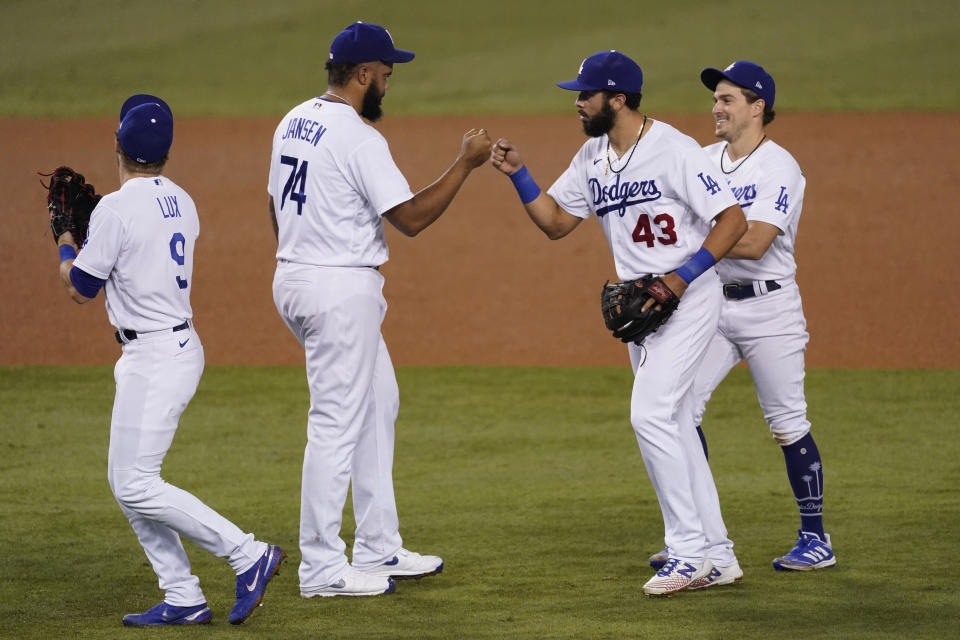 Los Angeles Dodgers' Gavin Lux, Kenley Jansen, Edwin Rios and Enrique Hernandez, from left, celebrate a 9-5 win over the Los Angeles Angels in a baseball game Friday, Sept. 25, 2020, in Los Angeles. (AP Photo/Ashley Landis)