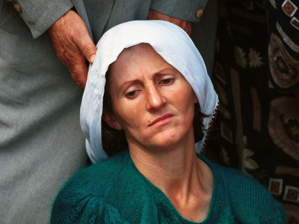 <p>An ethnic Albanian woman is supported as she mourns at the funeral of 34 KLA soldiers killed in a spring 1999 offensive against the Yugoslav Army at a mass funeral in Ferizaj, south of the Kosovo’s capital, Pristina, on Sept. 12, 1999. (Photo: Jacqueline Larma/AP) </p>