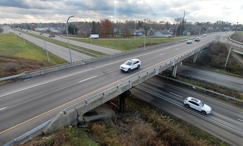 Traffic moves on the eastbound bridge, center, carrying U.S. Route 20, or West 26th Street, over Interstate 79 in Erie.