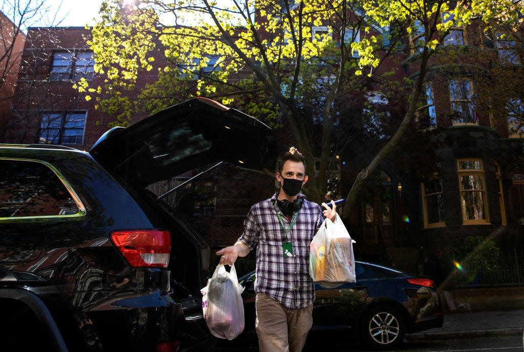 Instacart shopper, makes a grocery delivery during the coronavirus pandemic in Washington, DC, April 6, 2020.