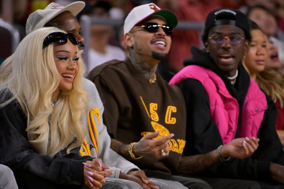 January 14, 2024: Rapper Saweetie, fashion designer Tracey Mills, and singer-songwriter Chris Brown attend the game between the USC Trojans and the UCLA Bruins at Galen Center.