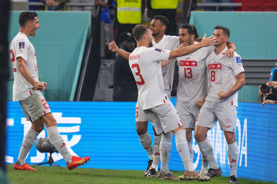 Switzerland's Remo Freuler, right, celebrates after scoring his side's third goal during the World Cup group G soccer match between Serbia and Switzerland, in Doha, Qatar, Friday Dec. 2, 2022. (AP Photo/Petr David Josek)