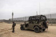 Israeli soldiers secure the site of a ceremony marking the completion of an enhanced security barrier along the Israel-Gaza border,Tuesday, Dec. 7, 2021. Israel has announced the completion of the enhanced security barrier around the Gaza Strip designed to prevent militants from sneaking into the country. (AP Photo/Tsafrir Abayov)