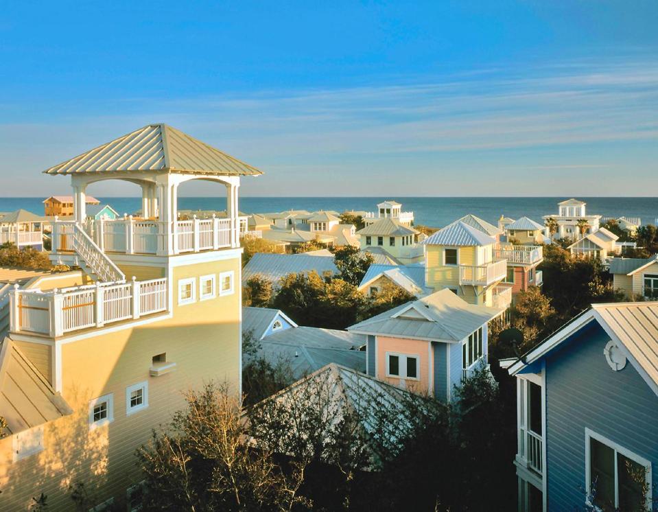 This undated image provided by Visit South Walton shows the picturesque town of Seaside, located in the Florida Panhandle. Seaside is known for its pastel-colored homes and beautifully landscaped walkways and public areas. Developed in 1981 as a planned resort community, Seaside was the setting of the 1998 film, “The Truman Show,” starring Jim Carrey. (AP Photo/Visit South Walton)