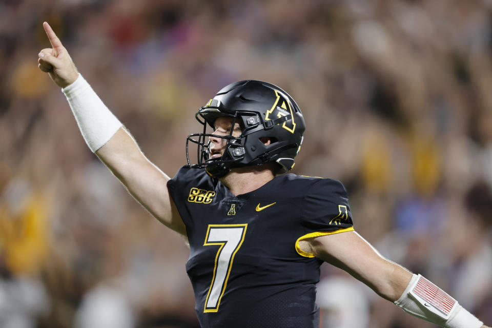 Appalachian State quarterback Chase Brice (7) celebrates after throwing a touchdown pass against East Carolina during the second half of an NCAA football game on Thursday, Sept. 2, 2021, in Charlotte, N.C. (AP Photo/Nell Redmond)
