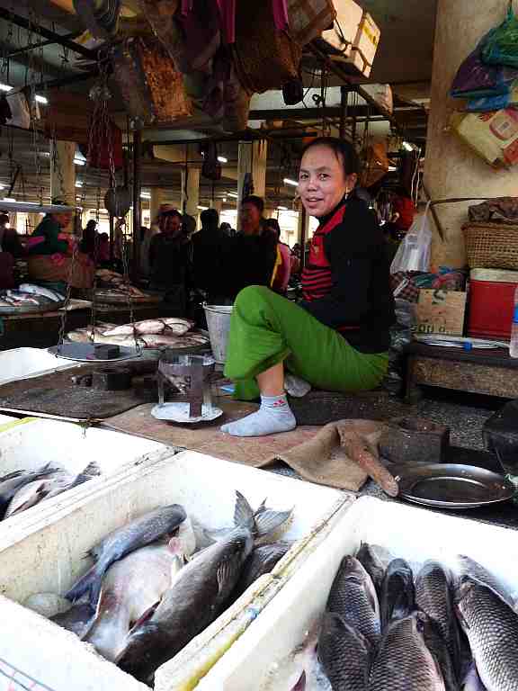 This cheerful Ima at the fish-market smiles for the camera.