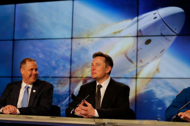 SpaceX founder and chief engineer Elon Musk reacts during a post-launch news conference to discuss the SpaceX Crew Dragon astronaut capsule in-flight abort test at the Kennedy Space Center