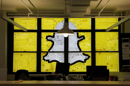 An image of the Snapchat logo created with Post-it notes is seen in the windows of Havas Worldwide at 200 Hudson Street in lower Manhattan, New York, U.S., May 18, 2016, where advertising agencies and other companies have started what is being called a "Post-it note war" with employees creating colorful images in their windows with Post-it notes. REUTERS/Mike Segar