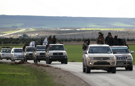 Turkish-backed Syrian rebels ride on trucks at Manbij countryside, Syria December 28, 2018. REUTERS/Khalil Ashawi