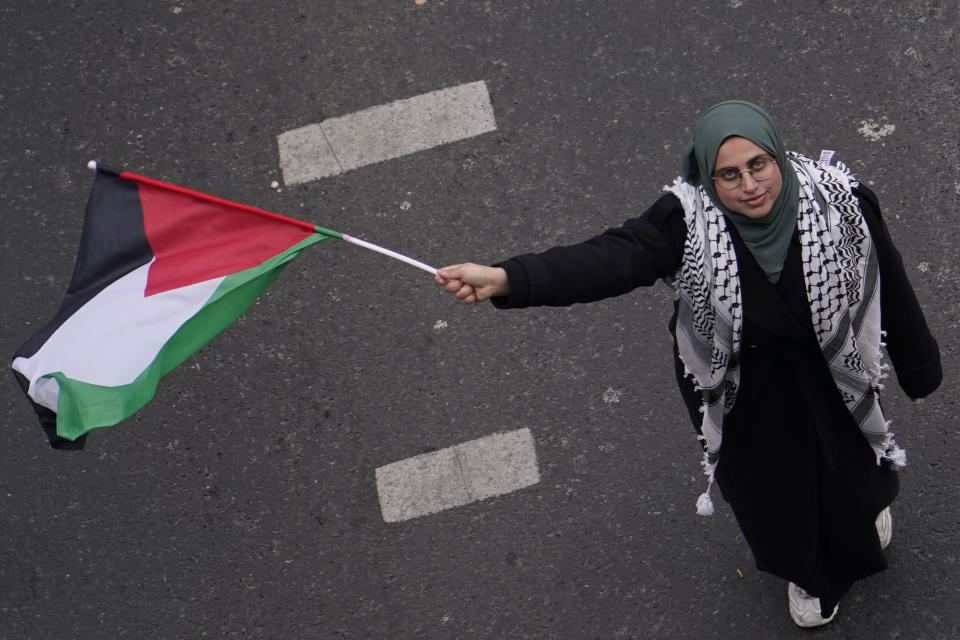 A Protester hold up a flag as she take part in a demonstration in support of Palestinian people in Gaza, in London, Saturday, Jan. 13, 2024.(AP Photo/Alberto Pezzali)