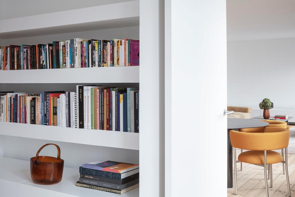 A peek inside the bedroom, which features floating shelves above the custom radiator covers.