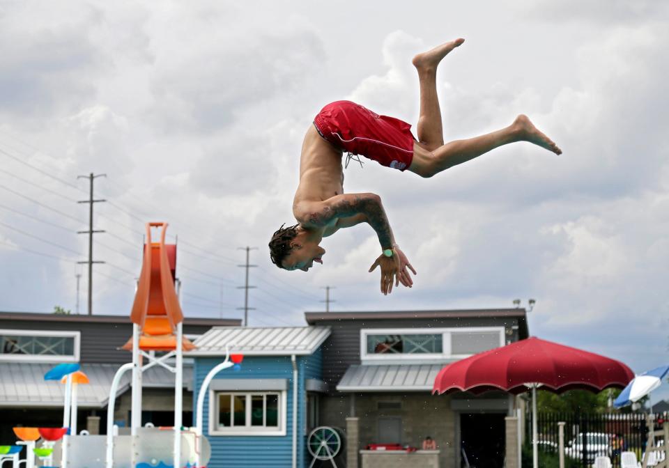 A lifeguard practices diving between swim sessions at the Dodge Pool. The pool is among three of Columbus' outdoor pools that will open for the season Memorial Day weekend.