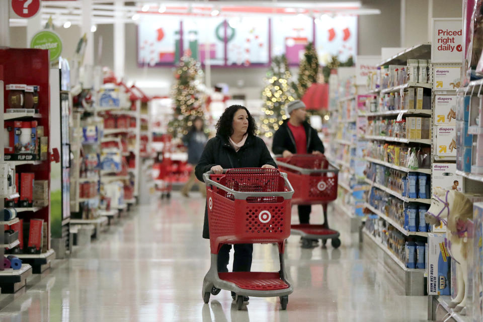 In this Friday, Nov. 16, 2018, photo, shoppers push carts while browsing isles at a Target store in Edison, N.J. Shoppers are spending freely heading into the holidays, but heavy investments and incentives like free shipping by retailers are giving Wall Street pause. Target Inc., Kohl’s Corp., Best Buy Co. and TJX Cos. all reported strong sales at stores opened at least a year. (AP Photo/Julio Cortez)