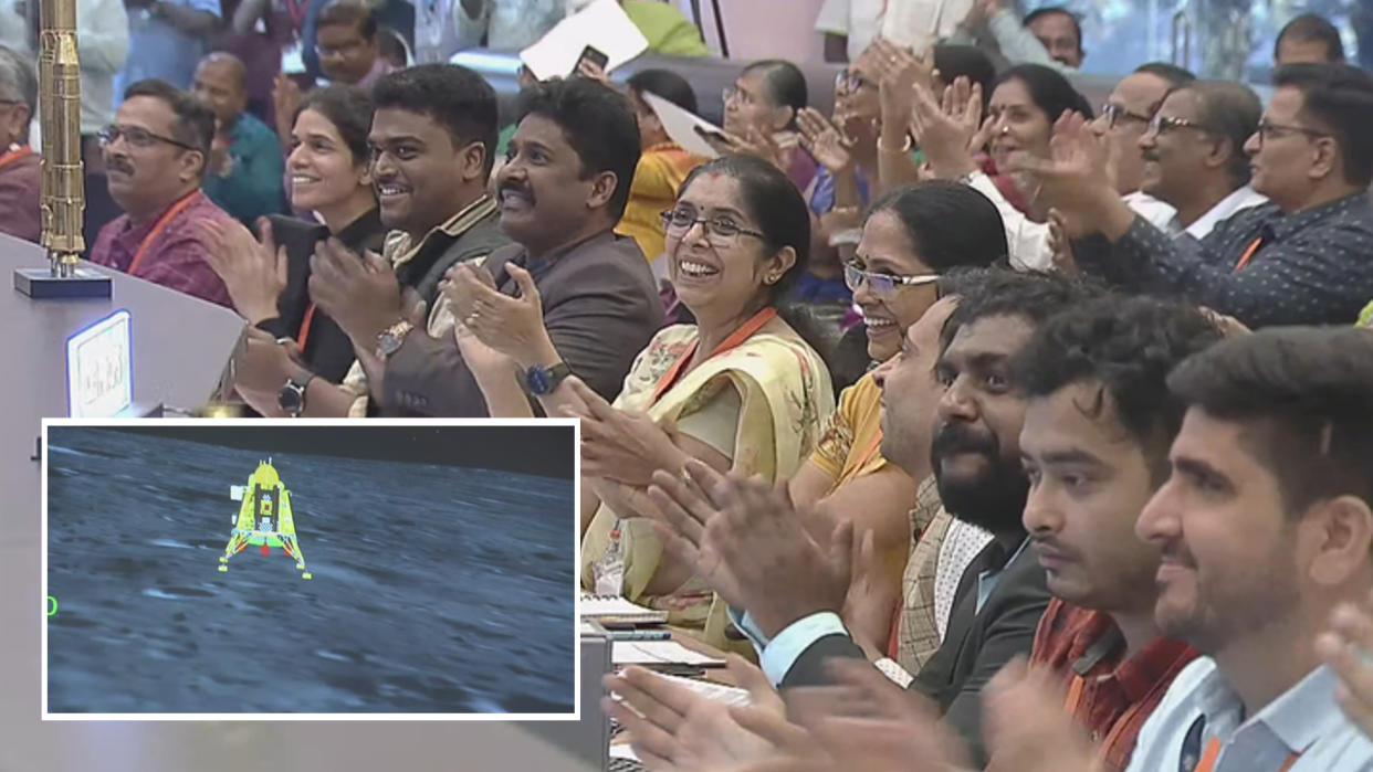  A crowd of engineers cheering with inset photo of spacecraft on moon 