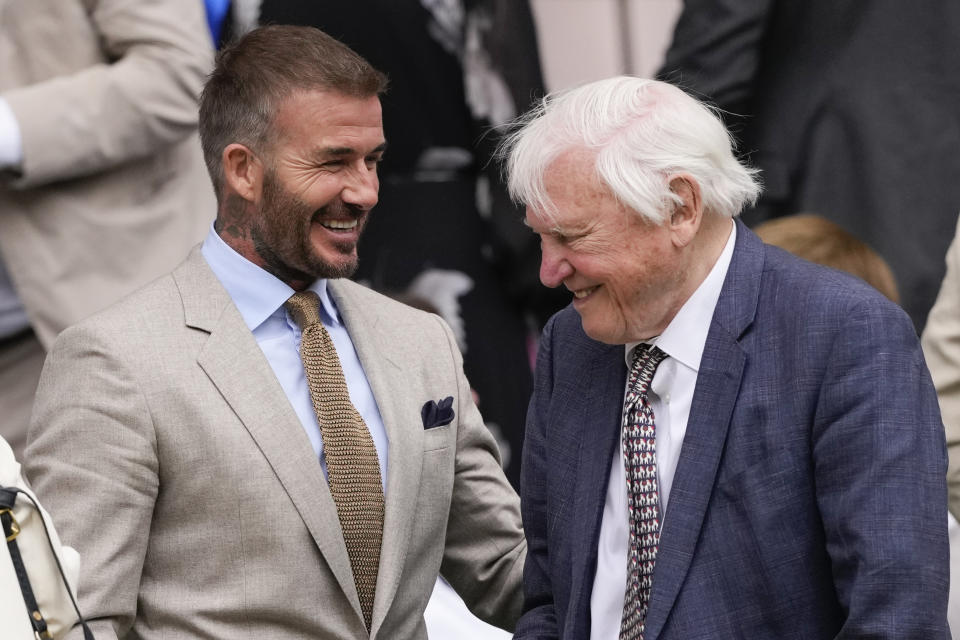 David Beckham, left, talks with Sir David Attenborough following the first round match between Carlos Alcaraz of Spain and Mark Lajal Estonia at the Wimbledon tennis championships in London, Monday, July 1, 2024. (AP Photo/Alberto Pezzali)