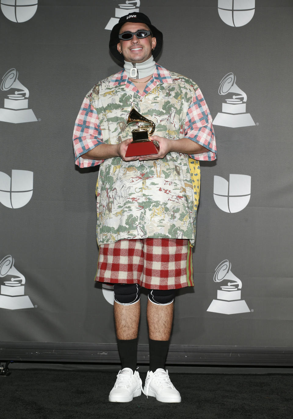 Bad Bunny poses in the press room with the award for best urban music album for "X 100Pre" at the 20th Latin Grammy Awards on Thursday, Nov. 14, 2019, at the MGM Grand Garden Arena in Las Vegas. (Photo by Eric Jamison/Invision/AP)