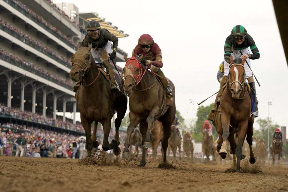 Brian Hernandez Jr. rides Mystik Dan, right, to the finish line to win the 150th running of the Kentucky Derby horse race at Churchill Downs Saturday, May 4, 2024, in Louisville, Ky. (AP Photo/Jeff Roberson)