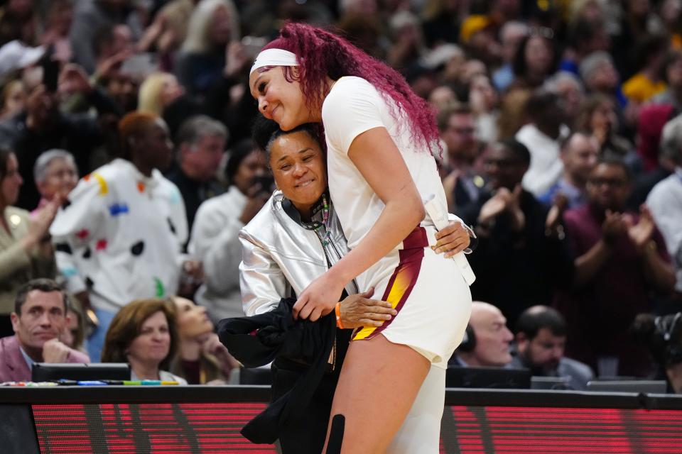 South Carolina center Kamilla Cardoso embraces coach Dawn Staley during the fourth quarter of the Gamecocks' win over Iowa in the women's NCAA Tournament title game.