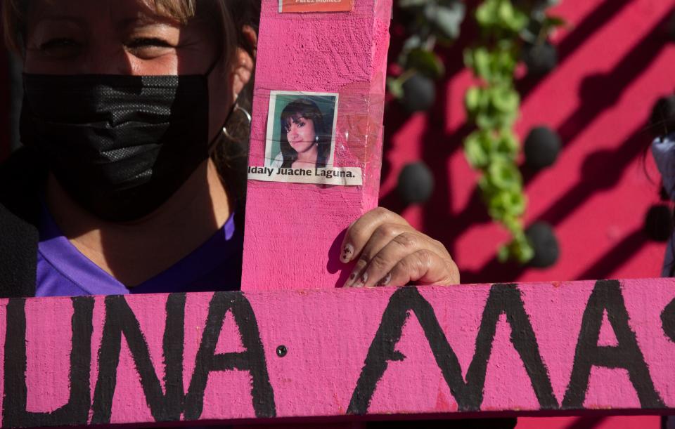 Susana Montes Rodriguez, whose daughter went missing and was found murdered, holds a cross with the photos of women murdered in Ju‡rez during a protest at the Paso del Norte Bridge in Juarez on International WomenÕs Day on March 8, 2023. 