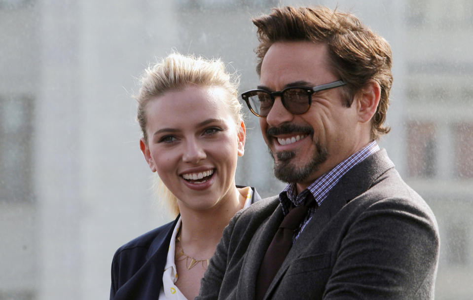 Actress Scarlett Johansson, left, and Actor Robert Downey Jr., pose for photographers at a hotel during a photocall for the film "Marvel" in Moscow, Russia, Tuesday, April 17, 2012. (AP Photo/Misha Japaridze)