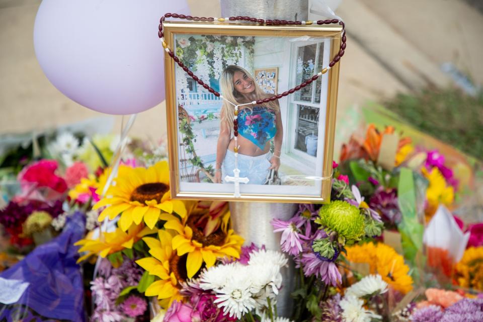 A framed photo of Florida State University sophomore Ellie Sims is placed above dozens of bouquets, candles and cards at the crosswalk sign located at the intersection of Lorene and Pensacola Streets on Wednesday, May 1, 2024. Sims was struck and killed by a driver on April 29, 2024.
