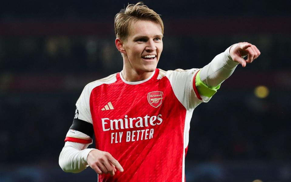 Martin Odegaard of Arsenal celebrates after scoring his side';s fifth goal during the UEFA Champions League match between Arsenal FC and RC Lens at Emirates Stadium on November 29, 2023 in London, England