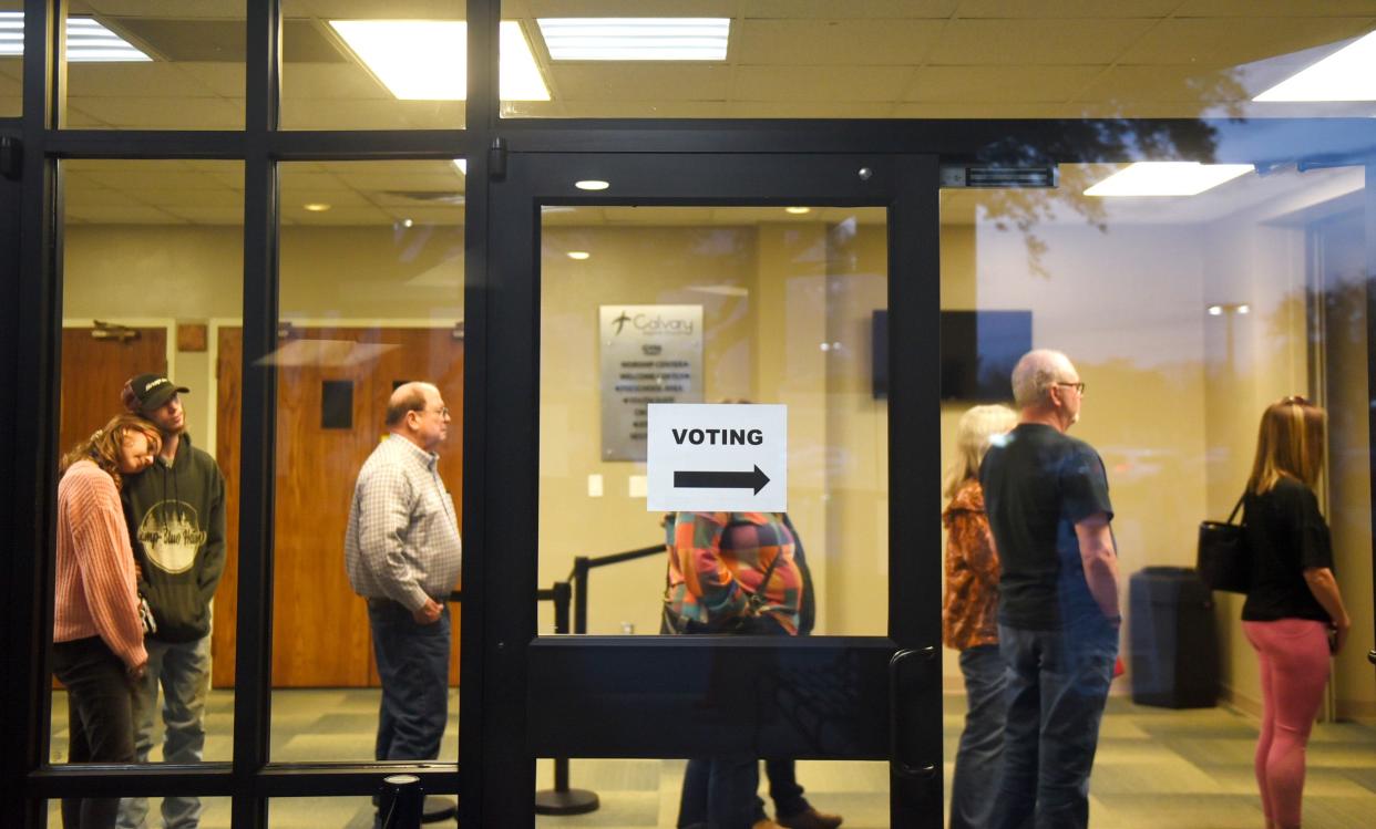 Voters wait in line at Calvary Baptist Church on Election Day, Tuesday, March 1, 2022. Polls are open this Saturday from 7 a.m. to 7 p.m.