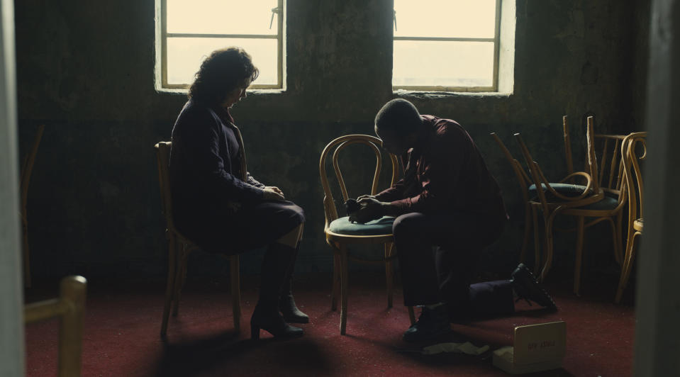 This image released by 20th Century Studios shows Olivia Colman and Micheal Ward, right, in a scene from "Empire of Light." (Searchlight Pictures via AP)