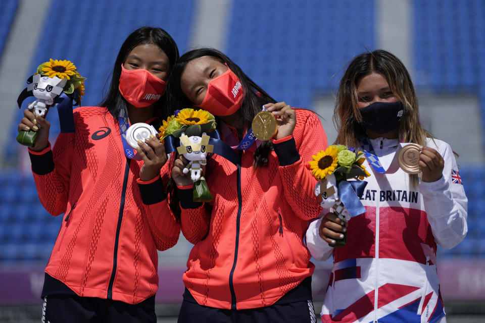 From left, silver medalist Kokona Hiraki of Japan, gold medalist Sakura Yosozumi of Japan and bronze medalist Sky Brown of Britain pose during a medals ceremony for the women's park skateboarding at the 2020 Summer Olympics, Wednesday, Aug. 4, 2021, in Tokyo, Japan. (AP Photo/Ben Curtis)