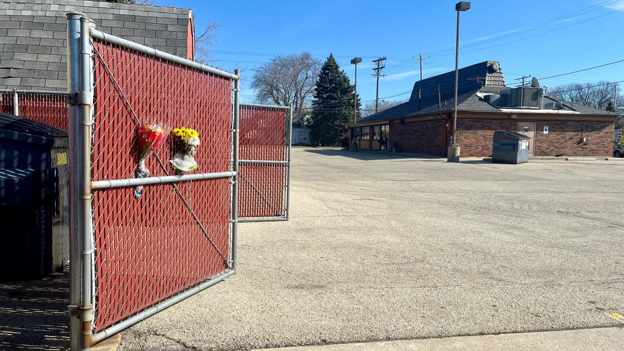 A memorial of flowers is seen mounted to the garbage enclosure at the South Milwaukee Pizza Hut, 124 N. Chicago Ave., on Feb. 12. Police are conducting a homicide investigation into the death of 55-year-old Alex Stengel of Cudahy, whose body was found there Feb. 7.