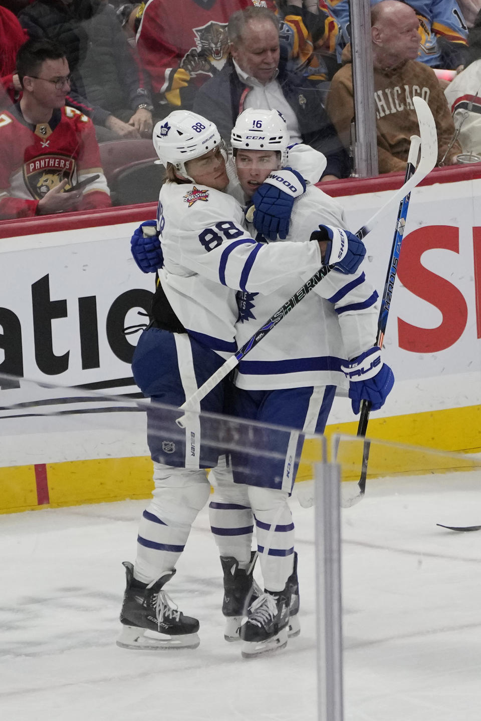 Toronto Maple Leafs right wing Mitchell Marner (16) is congratulated by right wing William Nylander (88) after scoring a goal during the second period of an NHL hockey game against the Florida Panthers, Thursday, Oct. 19, 2023, in Sunrise, Fla. (AP Photo/Marta Lavandier)