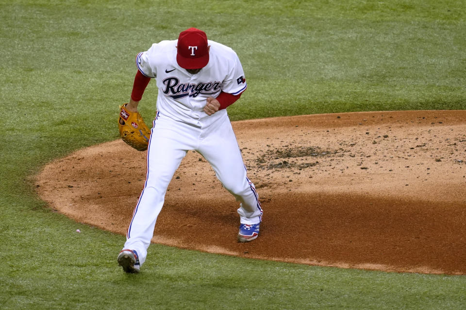 Texas Rangers starting pitcher Martin Perez celebrates after striking out Seattle Mariners' Sam Haggerty with the bases loaded during the second inning of a baseball game Thursday, July 14, 2022, in Arlington, Texas. (AP Photo/Tony Gutierrez)