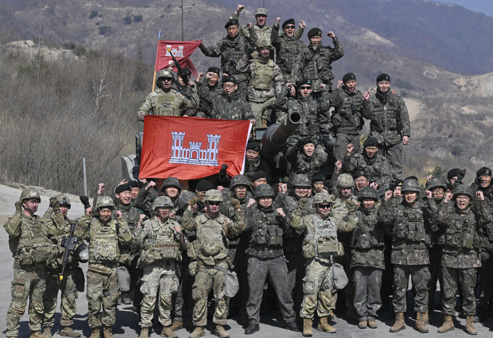 South Korean and U.S. soldiers pose for photos after their joint live fire exercise at a military training field in Pocheon, South Korea Thursday, March 14, 2024 as part of the annual Freedom Shield joint military exercise between South Korea and the United States. (Jung Yeon-je/Pool Photo via AP)