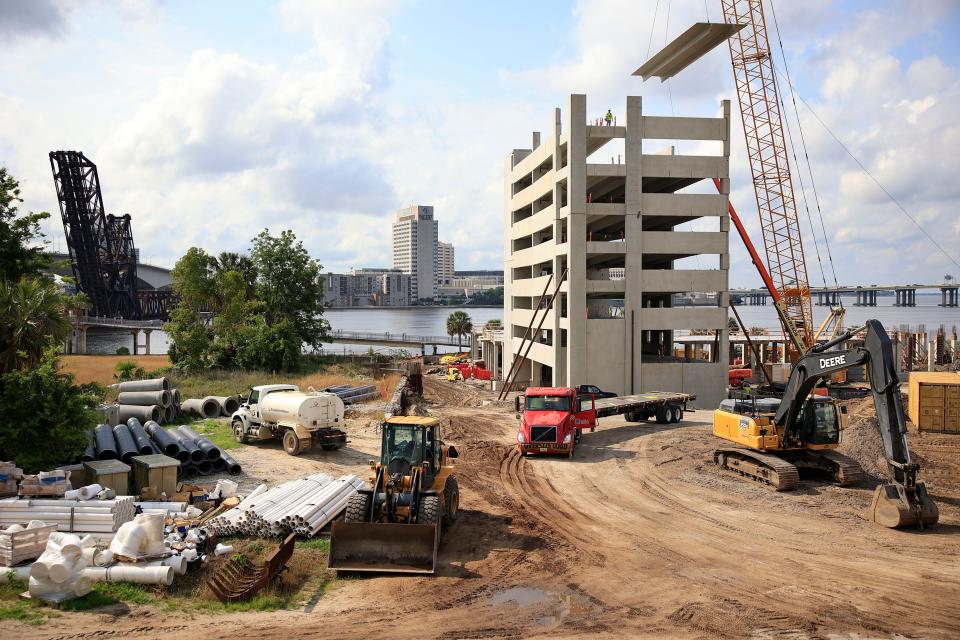 Construction personnel work to complete a mixed-use commercial project Wednesday, May 31, 2023 at 1 Riverside Dr. In Jacksonville, Fla. The land is being developed on Northbank of the St. Johns River, where the former Florida Times-Union building once stood, as vertical construction is underway in Phase 1 of the multi-million dollar project. It’s anticipated to include 271 luxury apartments, a parking garage, a Whole Foods Market, and space for retail shops and restaurants. 