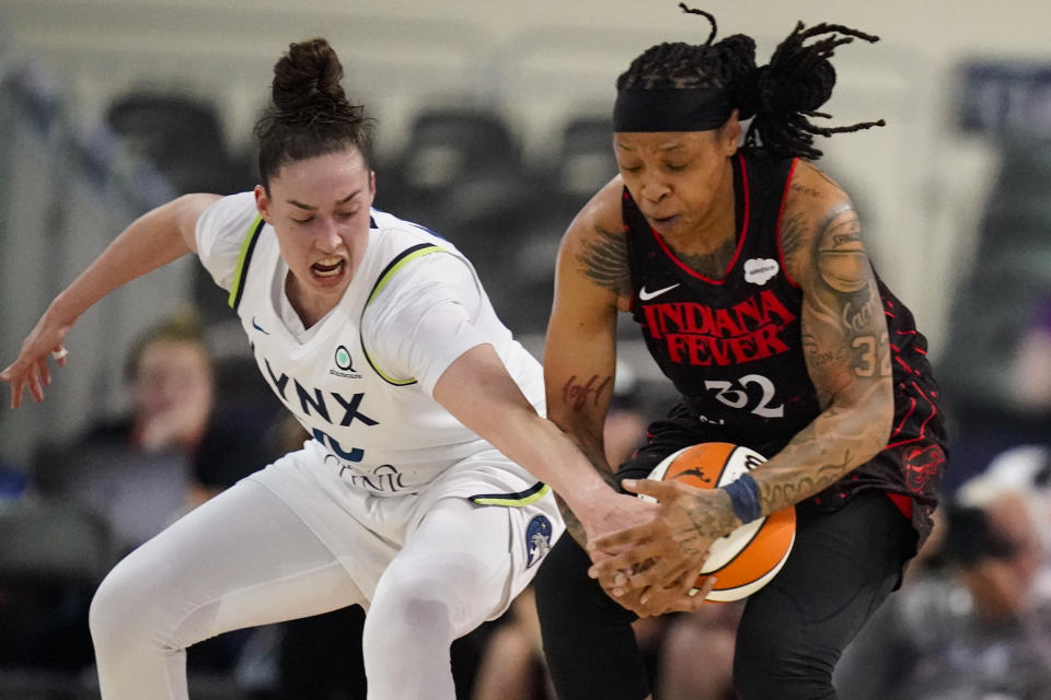 Minnesota Lynx forward Jessica Shepard (10) and Indiana Fever forward Emma Cannon (32) go for a loose ball in the first half of a WNBA basketball game in Indianapolis, Friday, July 15, 2022. (AP Photo/Michael Conroy)