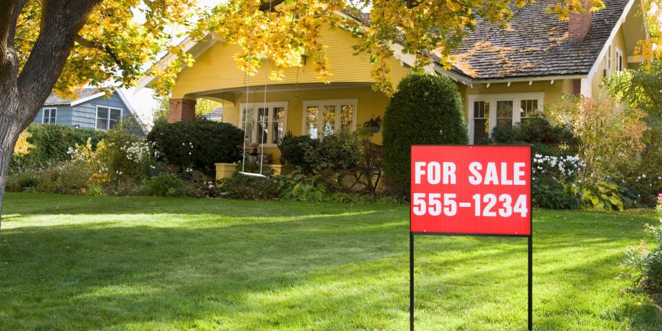 A house with a for sale sign.