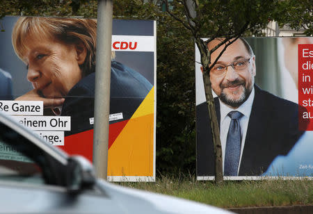 Election campaign posters for the upcoming general elections of the Christian Democratic Union party (CDU) with a headshot of German Chancellor Angela Merkel and of Germany's Social Democratic Party SPD candidate Martin Schulz are pictured in Berlin, Germany September 1, 2017. REUTERS/Reinhard Krause