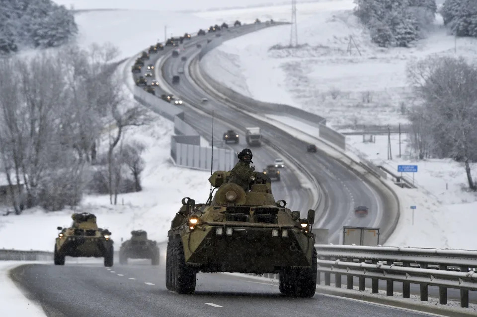 A convoy of Russian armored vehicles moves along a highway in Crimea