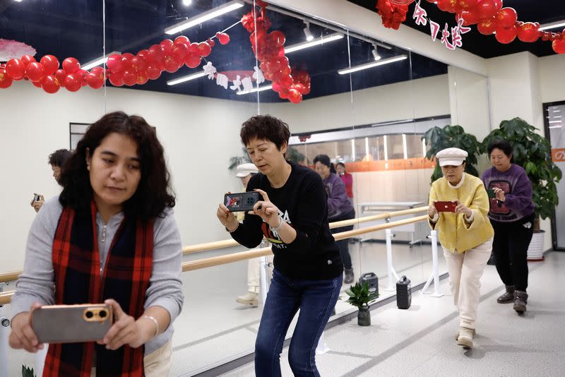 Women attend a smartphone photography class at Mama Sunset in Beijing