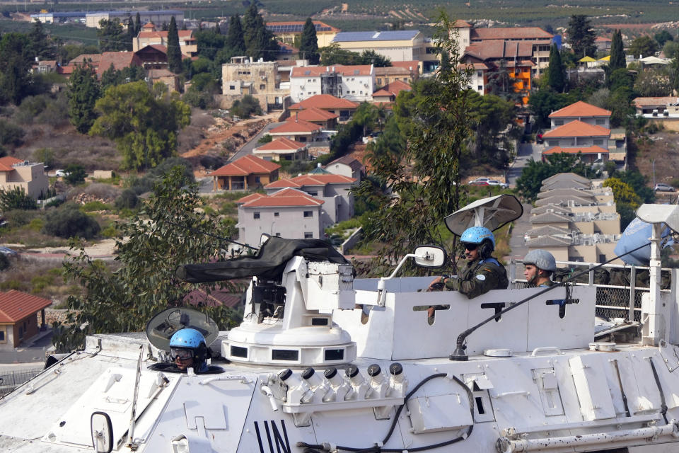 U.N. peacekeepers patrol on the Lebanese side of the Lebanese-Israeli border in the southern village of Kfar Kila, with the Israeli town of Metula in the background, Lebanon, Monday, Oct. 9, 2023. Lebanese and Israeli army soldiers have gathered in larger numbers along the border Monday, the U.N.-drawn Blue Line, after Israeli troops and militant group Hezbollah exchanged shelling on Sunday. (AP Photo/Hassan Ammar)