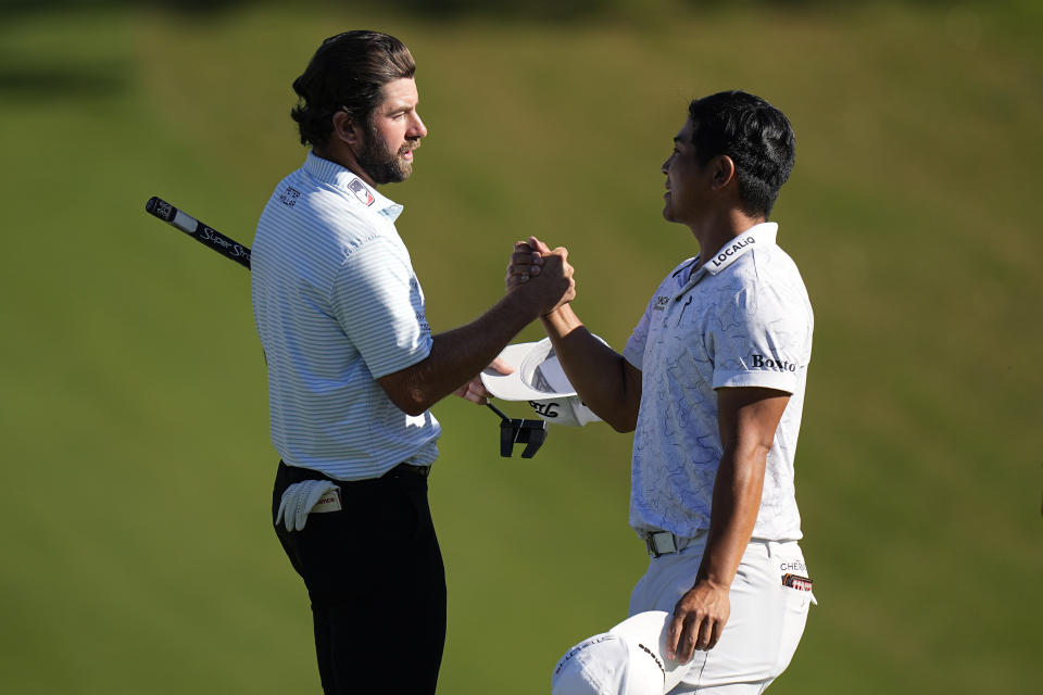 Cameron Young, left, is congratulated by Kurt Kitayama, right, after their quarterfinal round at the Dell Technologies Match Play Championship golf tournament in Austin, Texas, Saturday, March 25, 2023. Young won the match. (AP Photo/Eric Gay)