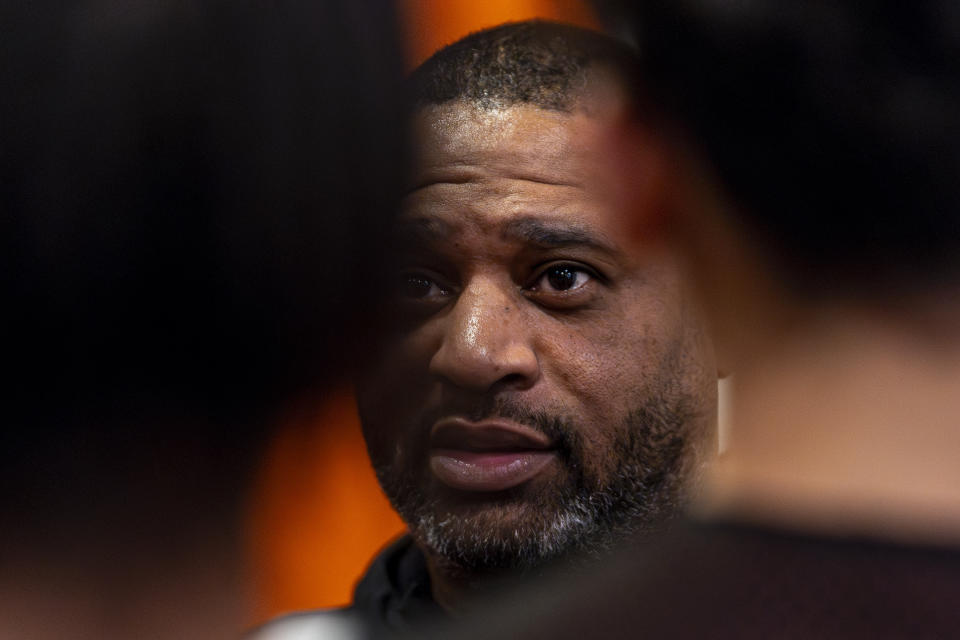 Book Richardson, director of the New York Gauchos boy's basketball program, speaks with his players in the locker room at the Gaucho Gym, Monday, March 11, 2024, in the Bronx borough of New York. Four assistant coaches arrested in a 2017 FBI probe designed to clean up college basketball are Black. All are out of the sport, banned by the NCAA. One coach, Book Richardson, tells The Associated Press he knows why: Because Black assistants were the low-hanging fruit — the ones on the front lines making connections with athletes who go on to play in college.(AP Photo/Peter K. Afriyie)