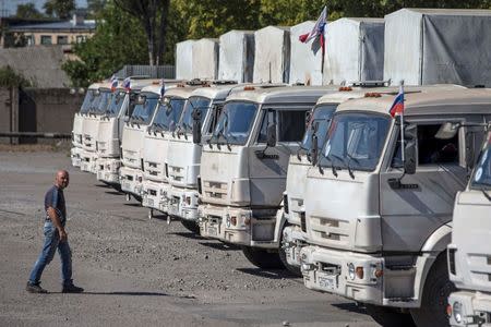 A man walks towards a Russian convoy of trucks carrying humanitarian aid in Donetsk, eastern Ukraine, September 20, 2014. REUTERS/Marko Djurica