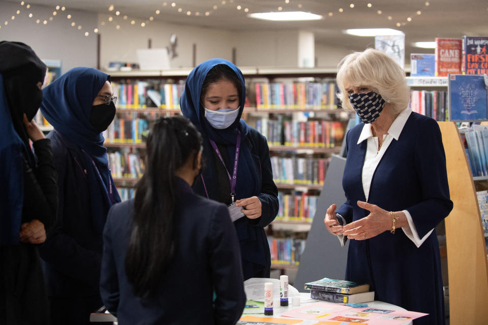 Britain's Camilla, Duchess of Cornwall, wearing a face covering to combat the spread of Covid-19, meets pupils from Eden Girls' School during her visit to Coventry Central Library in Coventry, central England on May 25, 2021. (Photo by Joe Giddens / POOL / AFP) (Photo by JOE GIDDENS/POOL/AFP via Getty Images)