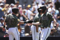 San Diego Padres' Jake Cronenworth (9) and Wil Myers celebrate after scoring on a double by Ha-Seong Kim against the Colorado Rockies in the first inning of a baseball game Sunday, Aug. 1, 2021, in San Diego. (AP Photo/Derrick Tuskan)