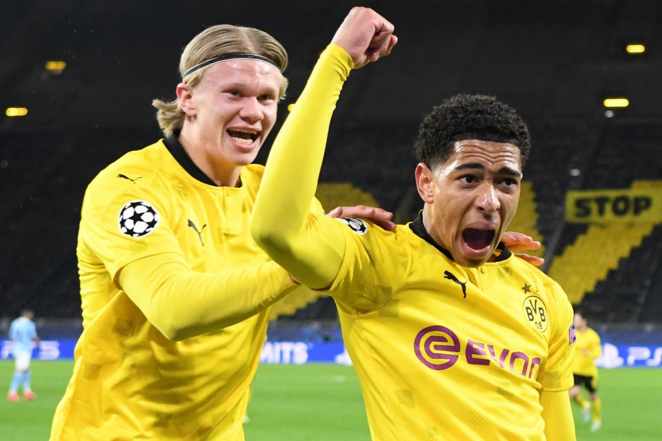 <p>Jude Bellingham celebrates with Borussia Dortmund team-mate Erling Haaland after scoring against Man City</p> (AFP via Getty Images)