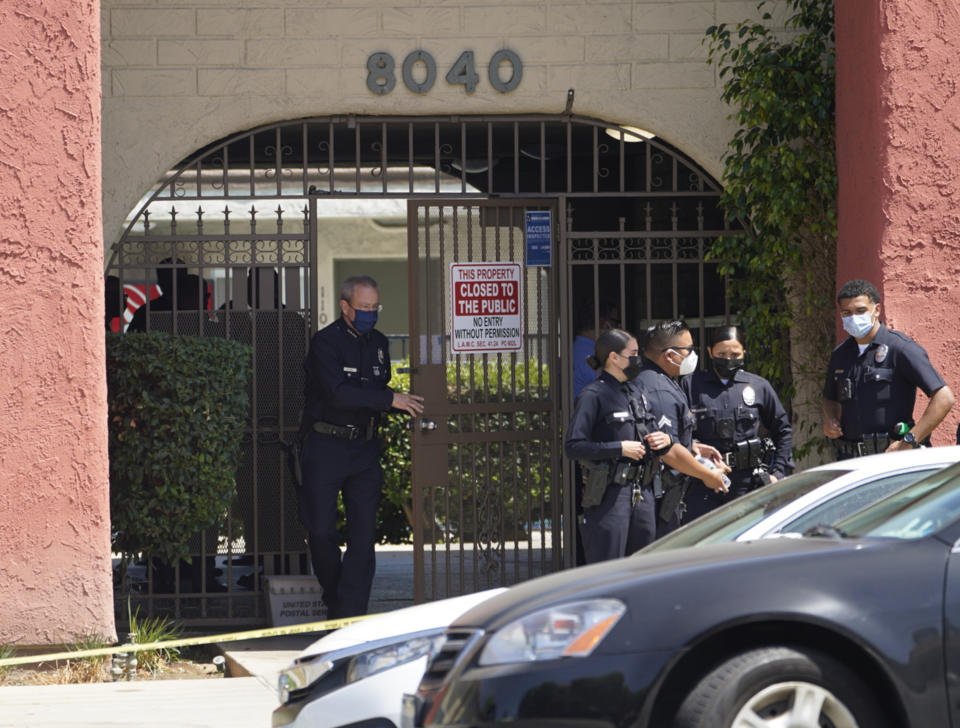 Los Angeles Police Chief Michel Moore exits an apartment complex as police investigate in Reseda, Calif., Saturday, April 10, 2021. The mother of three children — all under the age of 5 — found slain inside a Los Angeles apartment Saturday morning has been arrested, police said. (AP Photo/Damian Dovarganes)