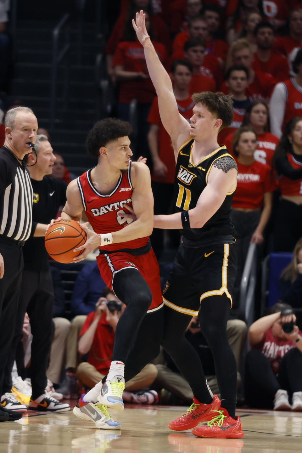 Dayton's Koby Brea (4) looks for an open pass as Virginia Commonwealth's Max Shulga, right, defends during the first half of an NCAA college basketball game Friday, March 8, 2024, in Dayton, Ohio. (AP Photo/Jay LaPrete)