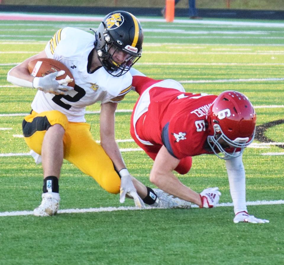 Watkins Memorial's Cooper Hunt intercepts while defending Johnstown's Jacob Hochanadel on Friday.